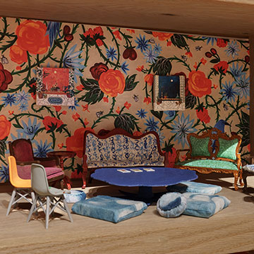 A miniature model of the Salon installation displayed on a wooden shelf.