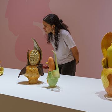 A museum guest looking at ceramic sculptures at the Nerman Museum.