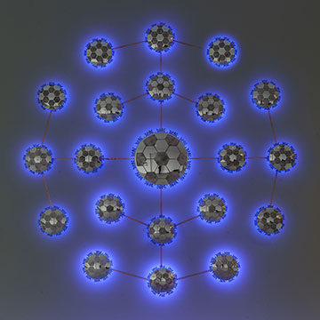 A glowing sculpture made of mirrored soccer balls, by Betsabee Romero at the Nerman Museum of Contemporary Art
