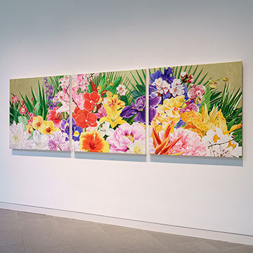 A triptych of colorful, painted flowers by Carlos Rolon on display at the Nerman Museum